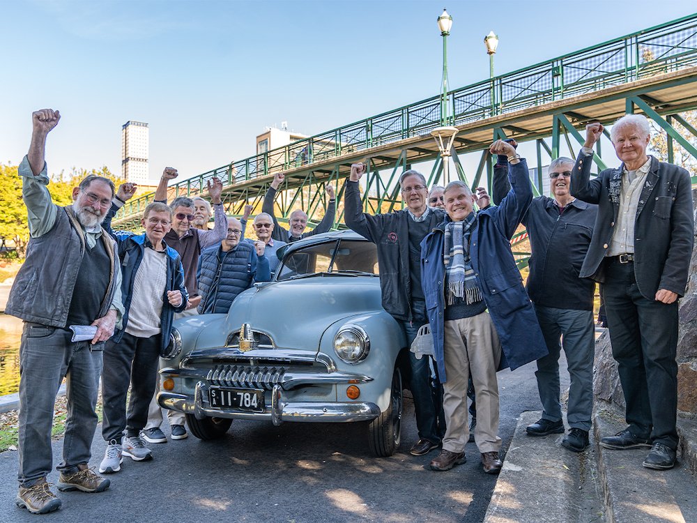 Prosh prank perpetrators with an FJ Holden