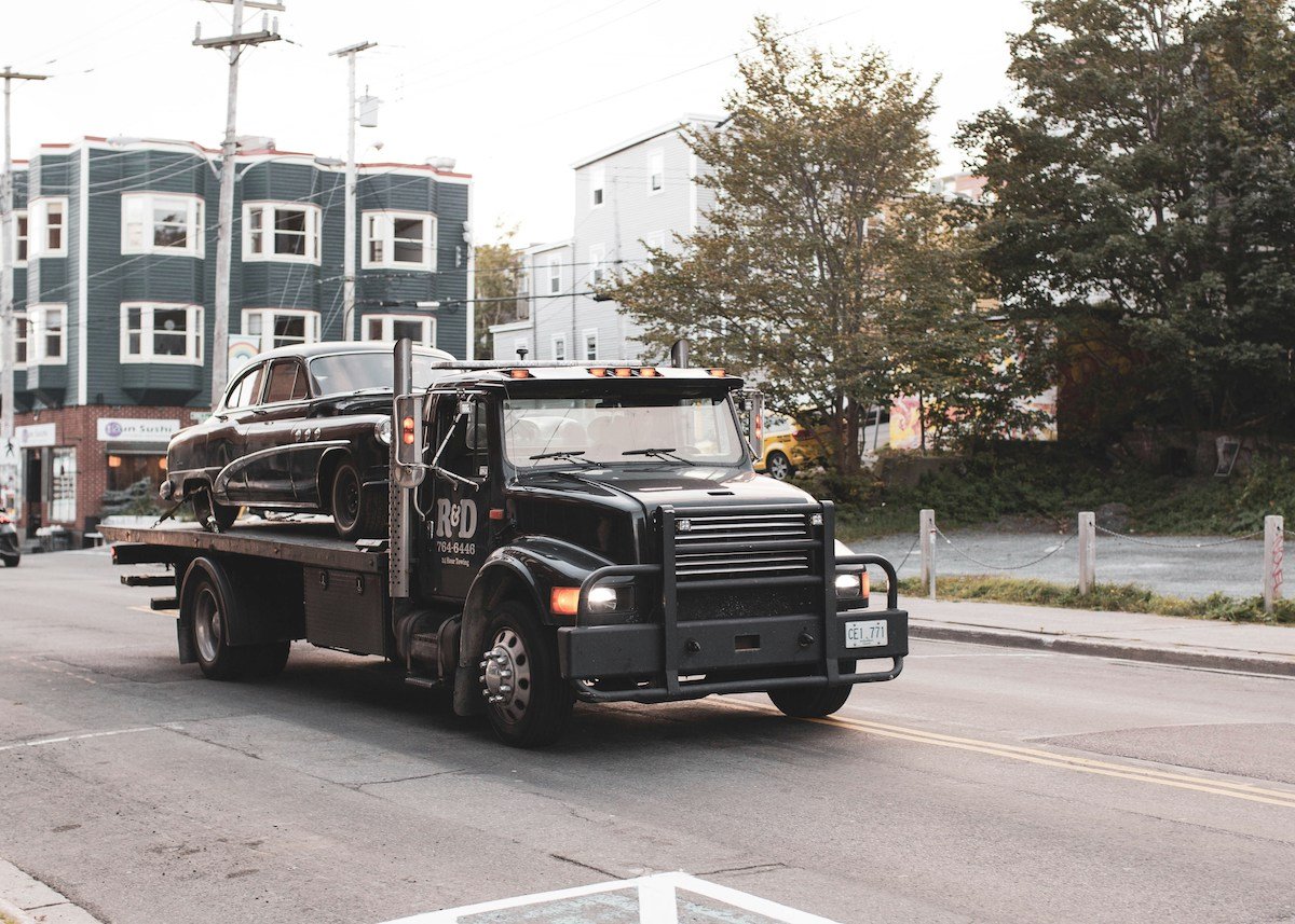 Classic car on tow truck