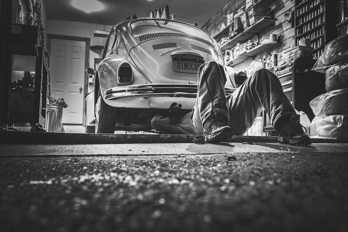 Man working on engine of VW Beetle