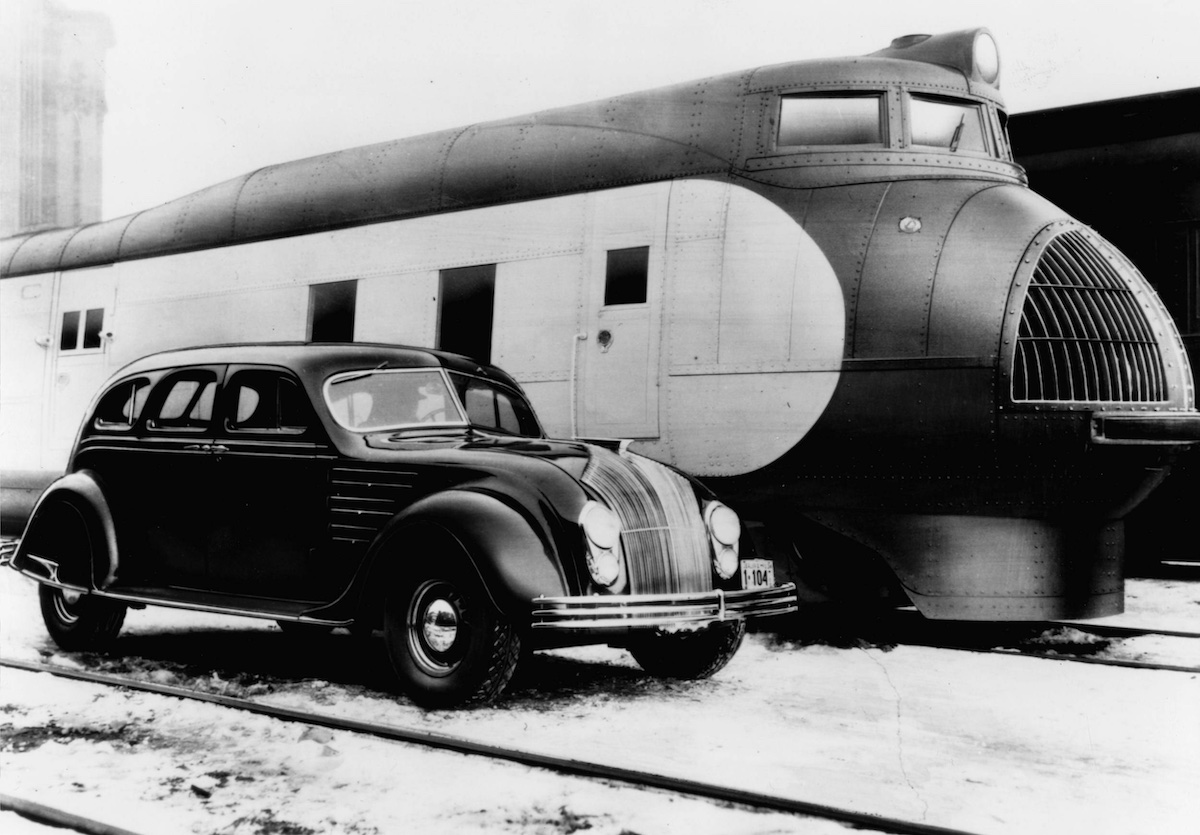 The world's first streamlined automobile, the Chrysler Airflow, posed beside the world's first streamlined train, Union Pacific's M-10000, in 1934
