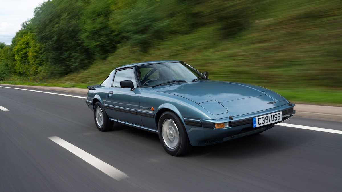 Mazda RX-7 FB driving on a country road