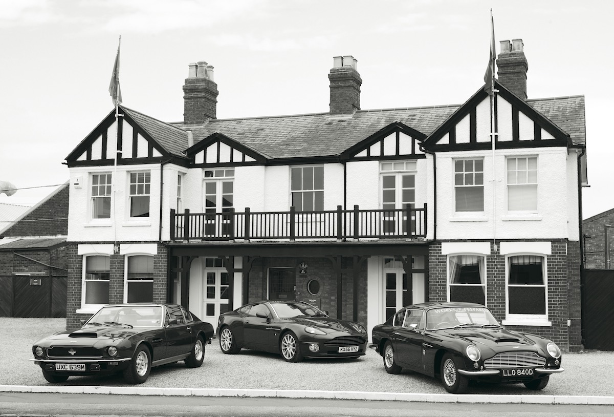 Three Aston Martins parked in front of the Sunnyside building at the company's headquarters
