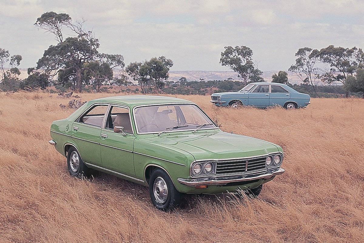 Two Chrysler Centuras parked in a grassy paddock