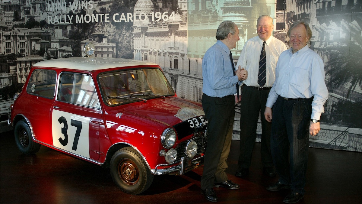 Paddy Hopkirk, Timo Mäkinen, and Rauno Aaltonen with the Mini they drove to victory in the 1964 Monte Carlo Rally