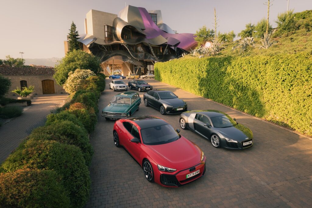 Group of Audi cars from the past 60 years parked in front of Hotel Marques de Riscal