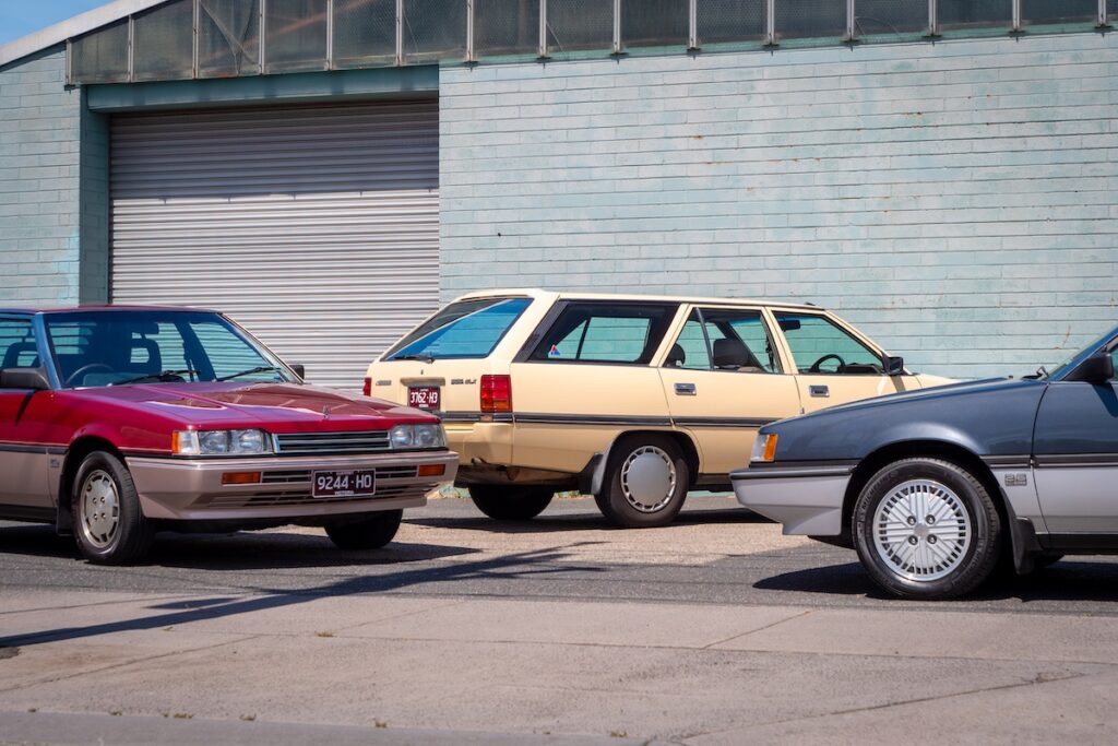 Three Mitsubishi Magna cars, with a close-up angle of the front of each car