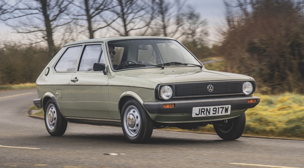 Volkswagen Polo driving down British country road