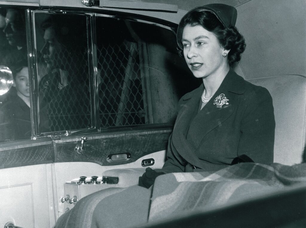 Queen Elizabeth II in the back of a Rolls-Royce Phantom IV Landaulette