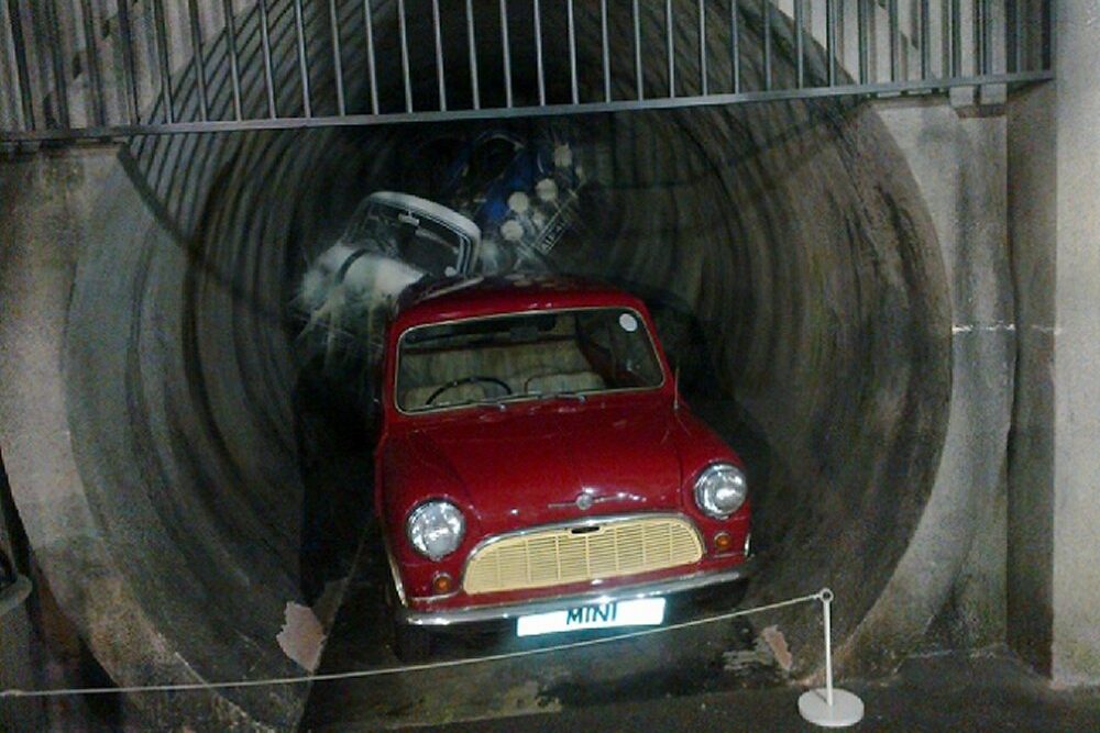 A Mini emerging from a tunnel, representing one of the most famous chase scenes from the iconic movie 'The Italian Job', filmed in Coventry's sewers as the sewers in Milan were too small.