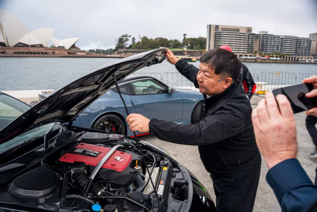 Yutaka Sanada opening the bonnet of the Nismo 380RS