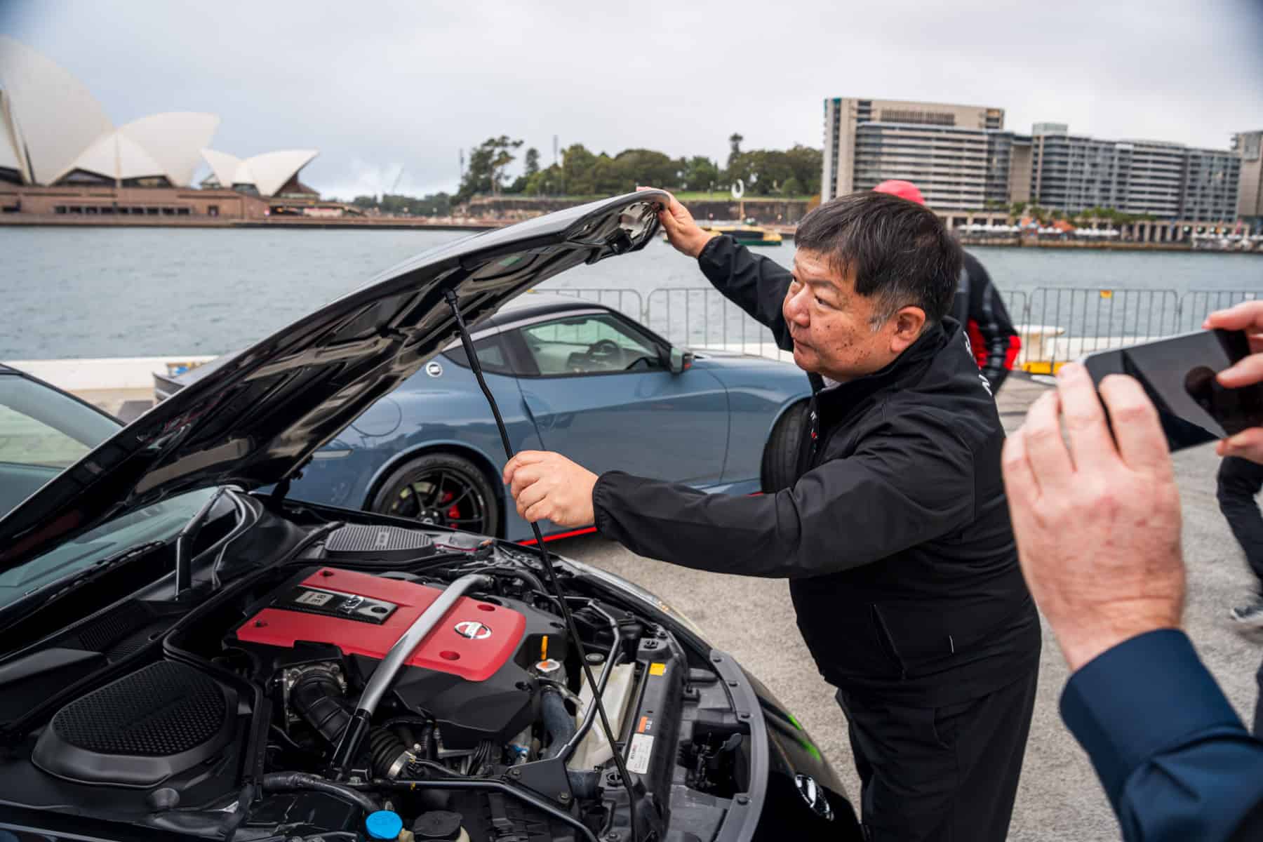 Yutaka Sanada opening the bonnet of the Nismo 380RS