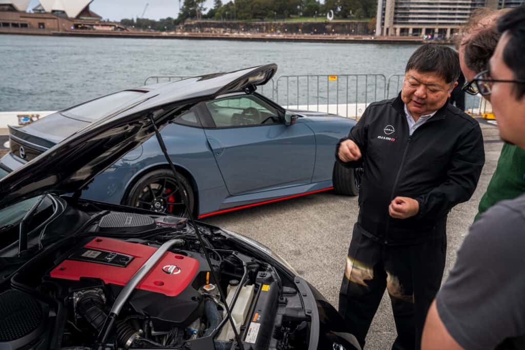 Yutaka Sanada talking to journalists about the Nismo 380RS