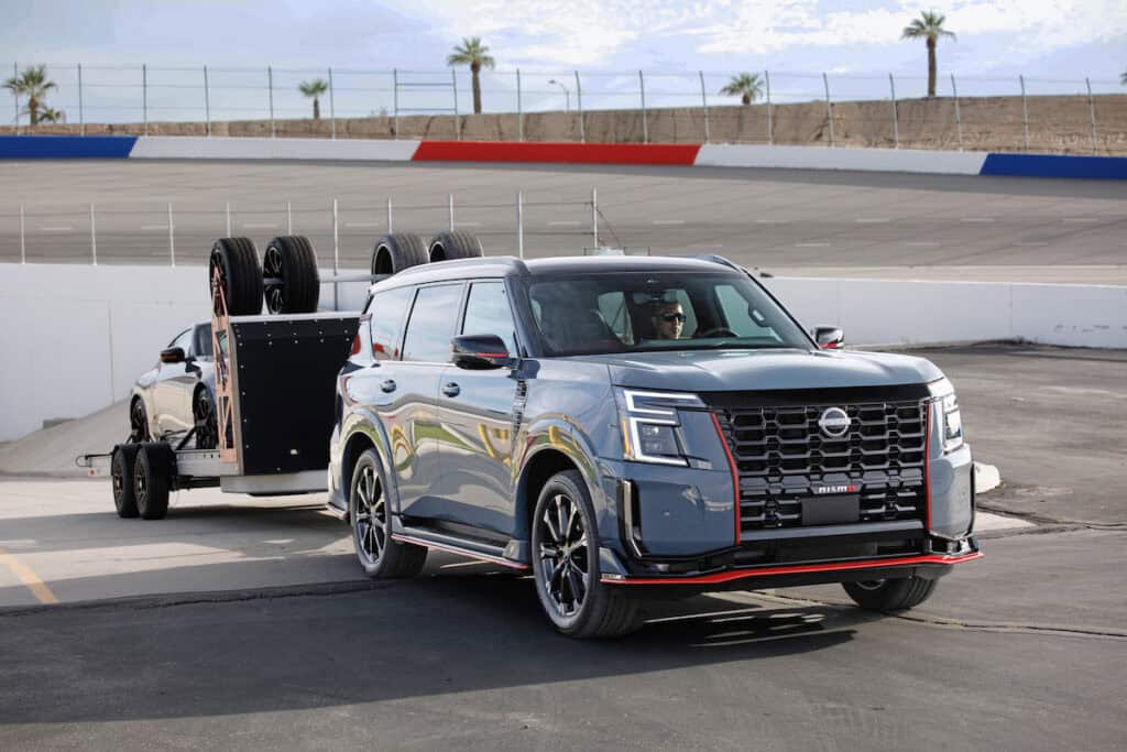 2026 Nissan Armada NISMO towing a Z