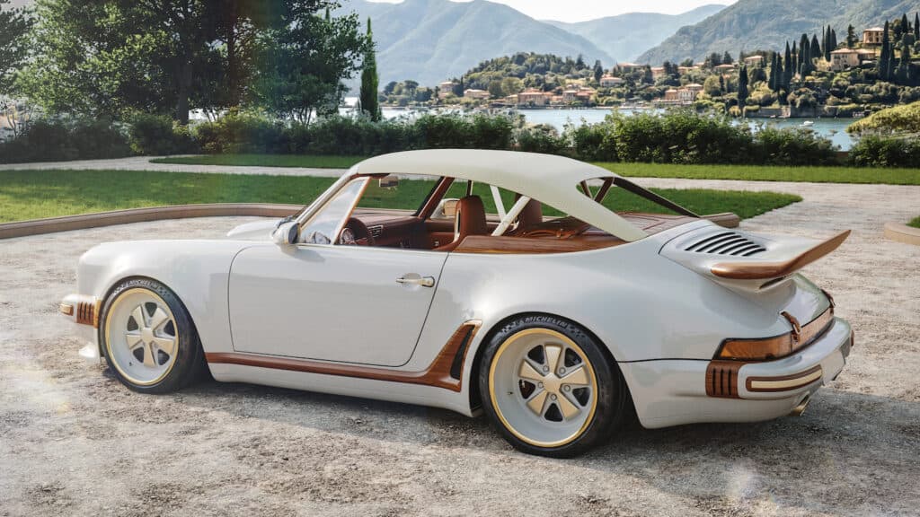 Side exterior profile - presented in Calcaire Lutétien White with wood accents Whale tail rear spoiler and lightweight canvas roof in the raised position